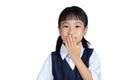 Asian Chinese little girl in uniform laughing and covering her m Royalty Free Stock Photo