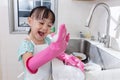 Asian Chinese little girl washing dishes in the kitchen Royalty Free Stock Photo