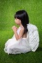 Asian Chinese little girl wearing angel wings and praying Royalty Free Stock Photo