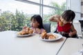 Asian Chinese little girls eating fried chicken Royalty Free Stock Photo