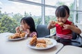 Asian Chinese little girls eating fried chicken Royalty Free Stock Photo