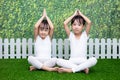 Asian Chinese little girls practicing yoga pose on a mat Royalty Free Stock Photo