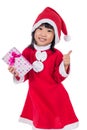 Asian Chinese little santa girl holding present with thumbs up Royalty Free Stock Photo