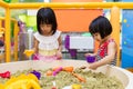 Asian Chinese Little Sister Playing Kinetic Sand Indoor