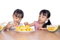 Asian Chinese little sisters eating durian fruit Royalty Free Stock Photo