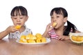 Asian Chinese little sisters eating durian fruit Royalty Free Stock Photo