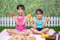 Asian Chinese little sisters having picnic