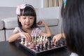 Asian Chinese little sisters playing chess together at home Royalty Free Stock Photo