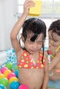 Asian Chinese little sisters playing in the inflatable pool Royalty Free Stock Photo