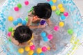 Asian Chinese little sisters playing in the inflatable pool Royalty Free Stock Photo