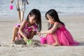 Asian Chinese little sisters playing sand Royalty Free Stock Photo