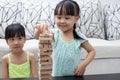 Asian Chinese little sisters playing wooden stacks Royalty Free Stock Photo