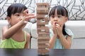 Asian Chinese little sisters playing wooden stacks Royalty Free Stock Photo
