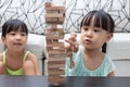 Asian Chinese little sisters playing wooden stacks Royalty Free Stock Photo