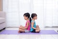 Asian Chinese little sisters practicing yoga pose on a mat Royalty Free Stock Photo