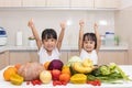 Asian Chinese little sisters thumbs up with fruit and vegetable Royalty Free Stock Photo