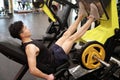 Asian chinese man in gym Ã¯Â¼ÅFitness sport man Training of leg strength in the gym Royalty Free Stock Photo