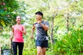 Asian Chinese man and woman jogging in city park Royalty Free Stock Photo