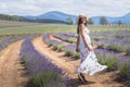 Portrait of beautiful romantic woman floral dress and stylish hat dain field of lavender flowers Royalty Free Stock Photo