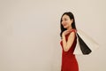 Asian Chinese modern fashionable woman girl shopping card and bag on hand in a mall white isolated background