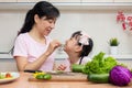 Asian Chinese mother and daughter making salad together