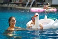 Asian chinese mother spending time with daughter at the swimming pool Royalty Free Stock Photo