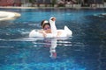 Asian chinese mother spending time with daughter at the swimming pool Royalty Free Stock Photo