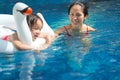 Asian chinese mother spending time with daughter at the swimming pool Royalty Free Stock Photo