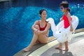 Asian chinese mother spending time with daughter at the swimming pool Royalty Free Stock Photo