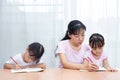 Asian Chinese mother teaching daughters doing homework Royalty Free Stock Photo