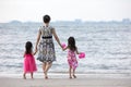 Asian Chinese mum and daughters playing sand together