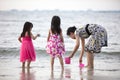 Asian Chinese mum and daughters playing sand together