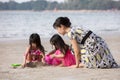 Asian Chinese mum and daughters playing sand together