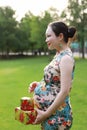 Asian Chinese pregnant woman present gift wrap on hands expect baby Merry Christmas holiday concept family parents mom