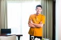 Asian Chinese room service waiter serving food in hotel suite Royalty Free Stock Photo