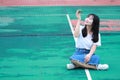 Asian Chinese university student play tennis on the playground Royalty Free Stock Photo