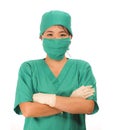 Young beautiful and happy medicine doctor or chief hospital nurse in green scrubs and surgey hat and mask wearing protective latex Royalty Free Stock Photo