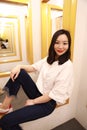 Asian Chinese woman in fitting Room look at herself from fitting mirror Royalty Free Stock Photo