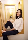 Asian Chinese woman in fitting Room look at herself from fitting mirror Royalty Free Stock Photo