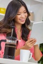 Asian Chinese Woman Girl in Kitchen Using Tablet Computer Royalty Free Stock Photo