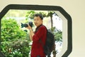 Close up Aisan Chinese man photographer hold camera work in nature