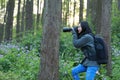 Portrait of a Asian Chinese nature woman photographer look at her camera screen in a spring park forest surround by flowers Royalty Free Stock Photo