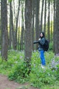 Portrait of a Asian Chinese nature woman photographer look at her camera screen in a spring park forest , with good hand gesture Royalty Free Stock Photo