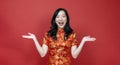 Asian chinese woman with red cheongsam or qipao exciting and laughing for wishing the good luck and prosperity in Chinese New Year