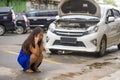 Asian Chinese woman in stress stranded on street suffering car engine failure having mechanic problem calling to insurance Royalty Free Stock Photo