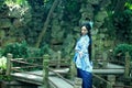 Asian Chinese woman in traditional Blue and white Hanfu dress, play in a famous garden on crooked Bridge Royalty Free Stock Photo