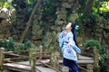 Asian Chinese woman in traditional Blue and white Hanfu dress, play in a famous garden on crooked Bridge Royalty Free Stock Photo