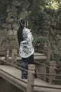 Asian Chinese woman in traditional Blue and white Hanfu dress, play in a famous garden on crooked Bridge Royalty Free Stock Photo