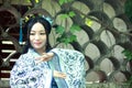 Asian Chinese woman in traditional Blue and white Hanfu dress, play in a famous garden near wall Royalty Free Stock Photo