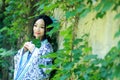 Asian Chinese woman in traditional Blue and white Hanfu dress, play in a famous garden near wall Royalty Free Stock Photo